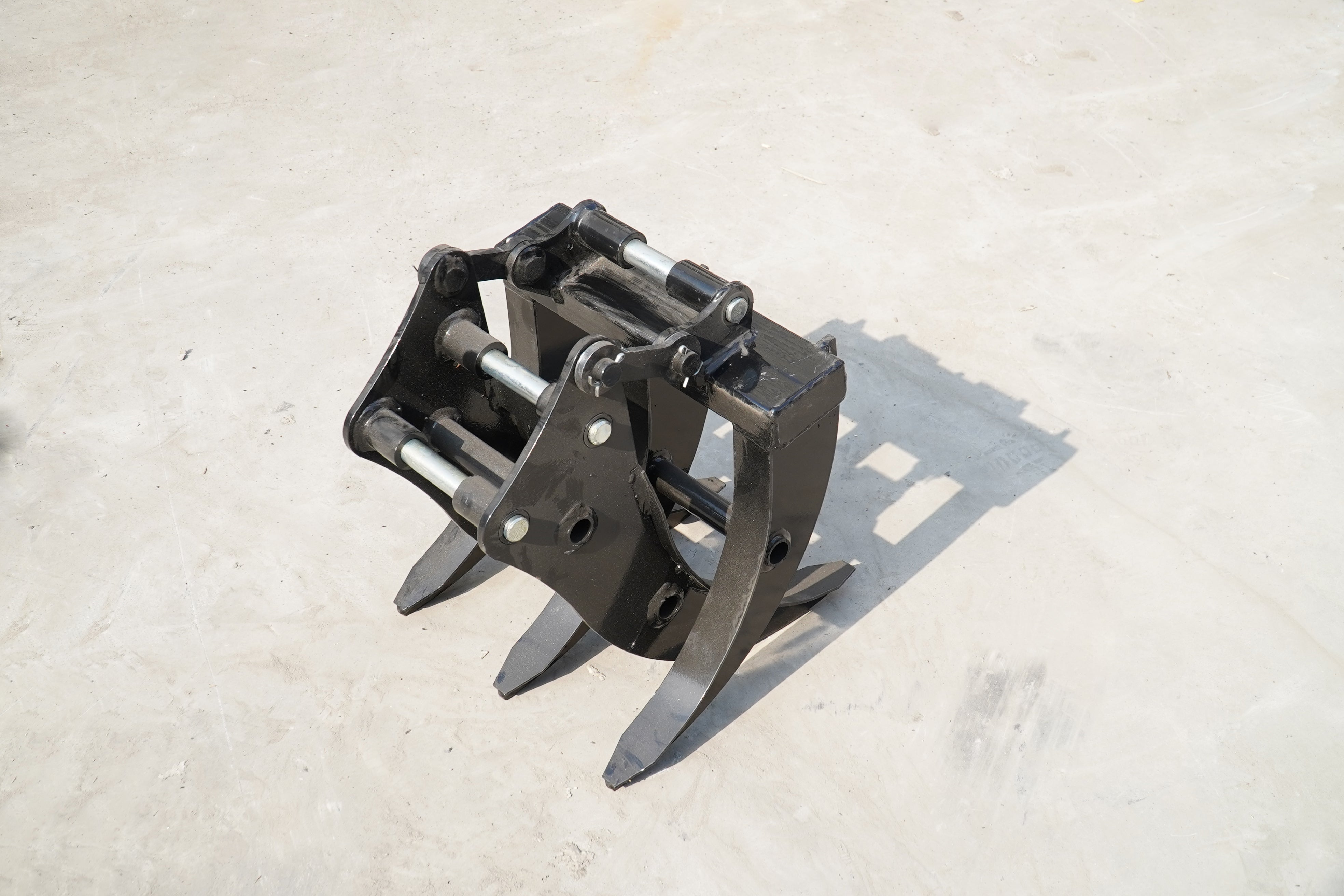 Heavy-duty excavator attachment showing claw grips designed for powerful digging and lifting tasks